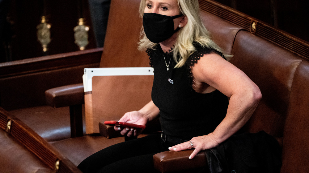 Marjorie Taylor Greene on cellphone in capitol