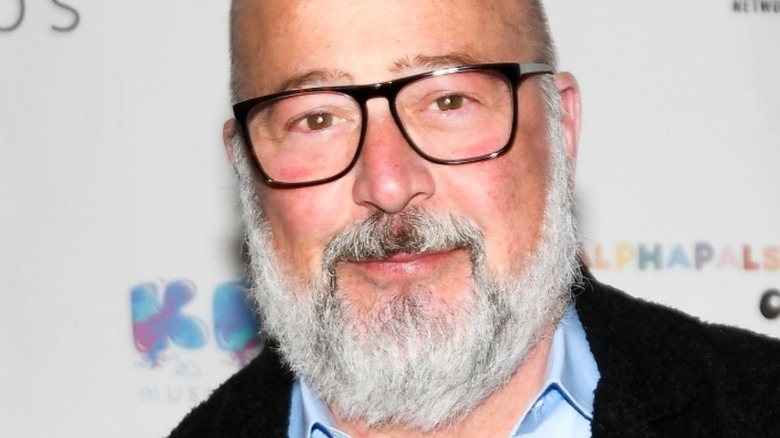 Andrew Zimmern with beard and slight smile