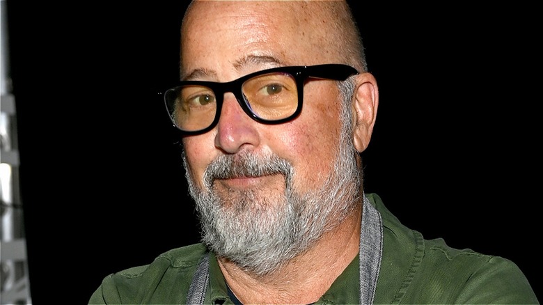 Andrew Zimmern wearing black glasses