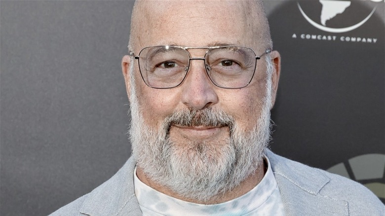 Andrew Zimmern with glasses and slight smirk