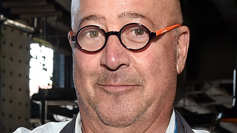Andrew Zimmern with glasses and slight smirk
