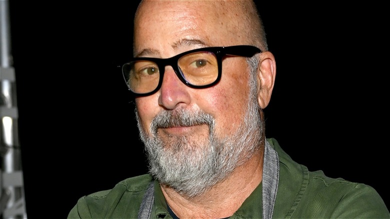 Andrew Zimmern wearing black glasses
