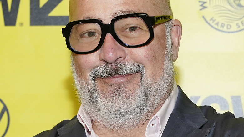 Andrew Zimmern wearing glasses with slight smile