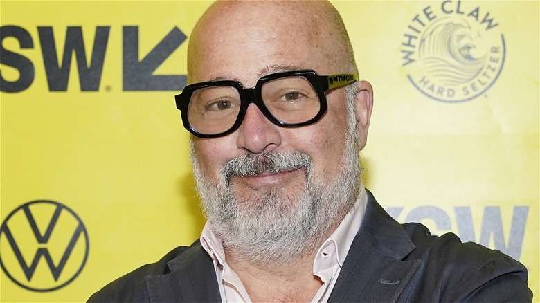 andrew zimmern wearing black-framed glasses