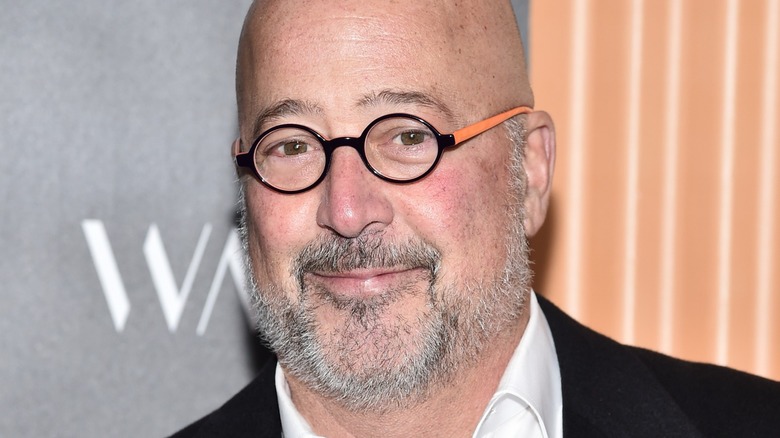 Andrew Zimmern in round glasses