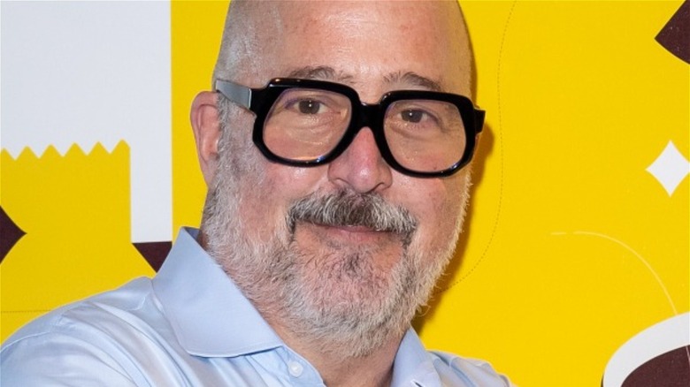 Andrew Zimmern in black glasses