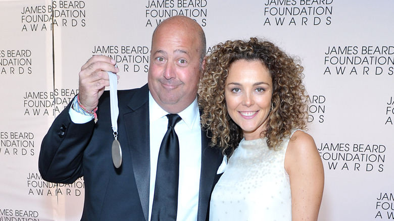 Andrew Zimmern holding a medal on the carpet of the James Beard Foundation Awards