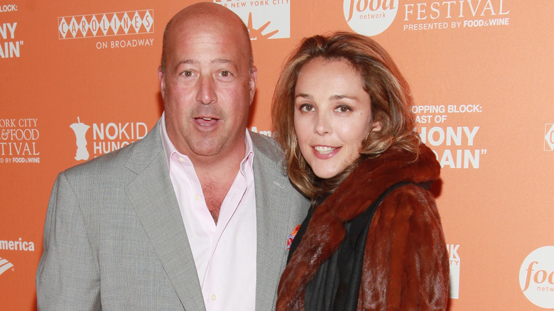Andrew Zimmern and ex-wife Rishia posing at a Food Bank event