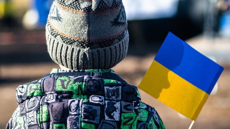 Child holding a Ukrainian flag