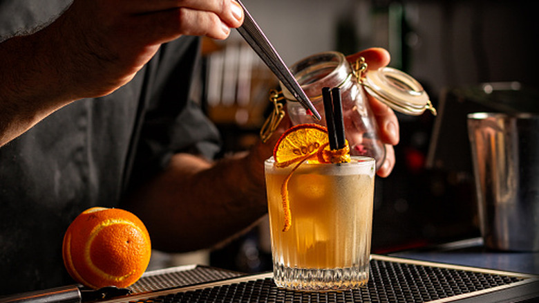 Bartender garnishing a cocktail