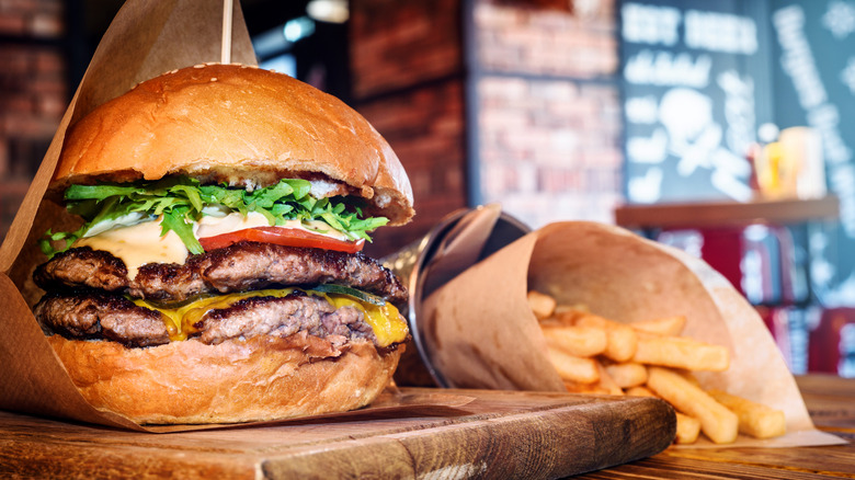 Burger and fries on a wooden bar