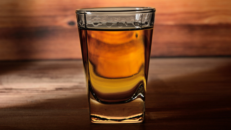 A full shot glass on the bar