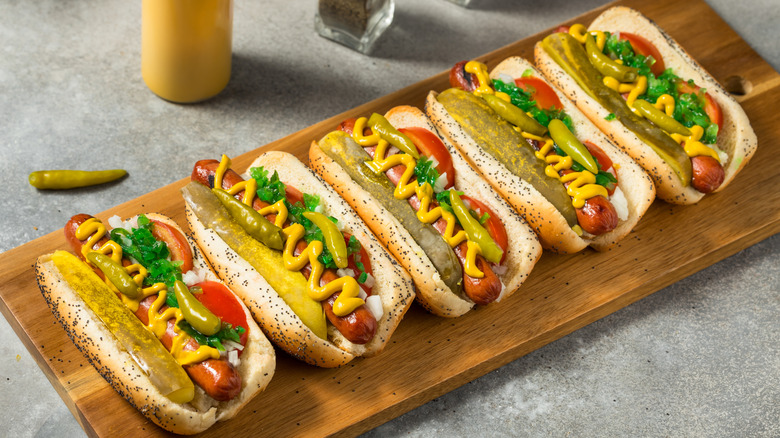 Chicago-style hot dogs on wooden board