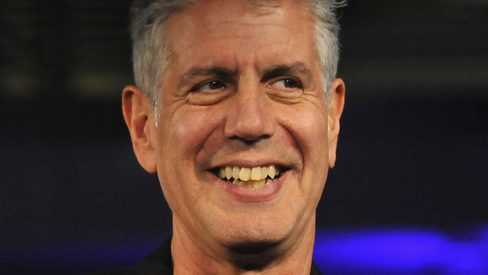 Anthony Bourdain smiling and pointing