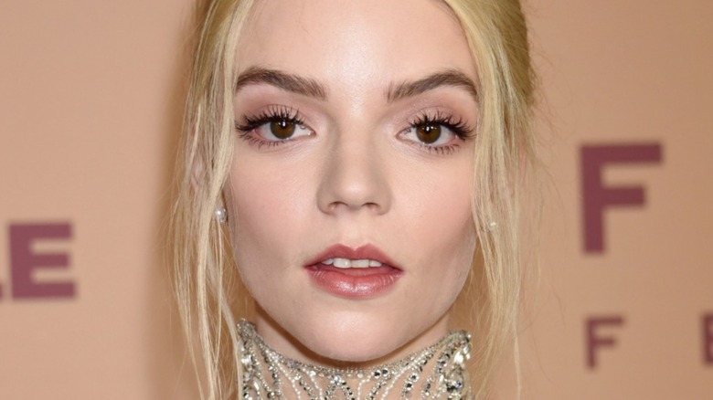 A close-up of Anya Taylor-Joy with her lips slightly pursed