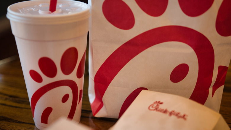Chick-fil-A drink and bags on table