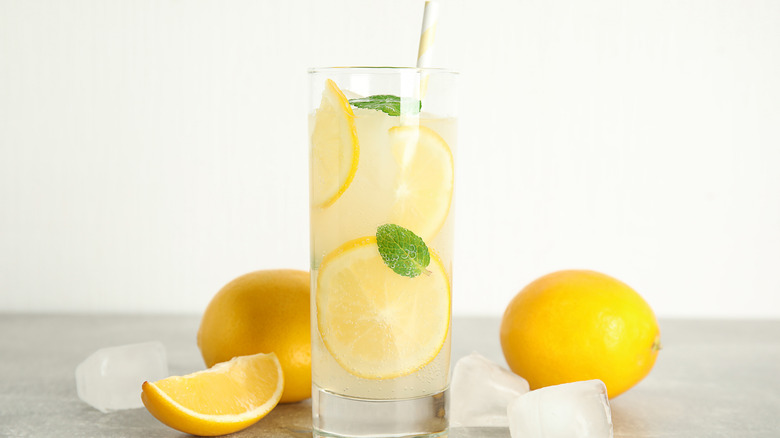 lemonade surrounded by lemons and ice.