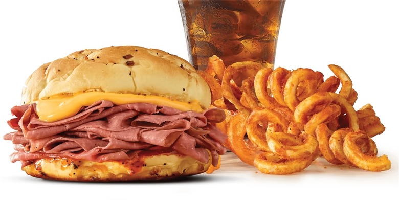 Arby's roast beef sandwich, curly fries, and soda