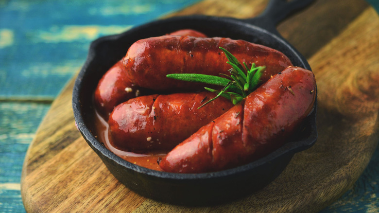 Grilled chorizo in cast iron pan with sauce