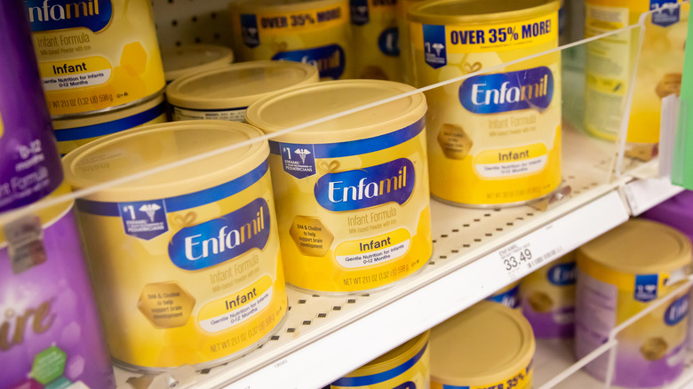 tubs of enfamil baby formula on store shelf