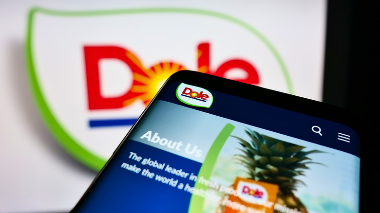 phone featuring Dole webpage in front of Dole logo