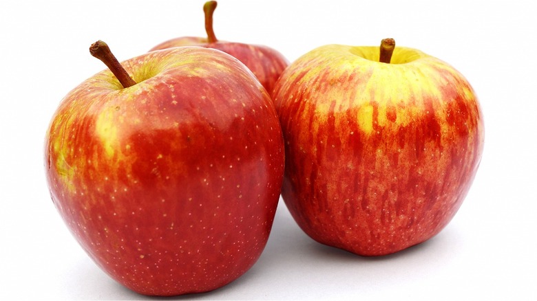 Three Fuji apples on white background