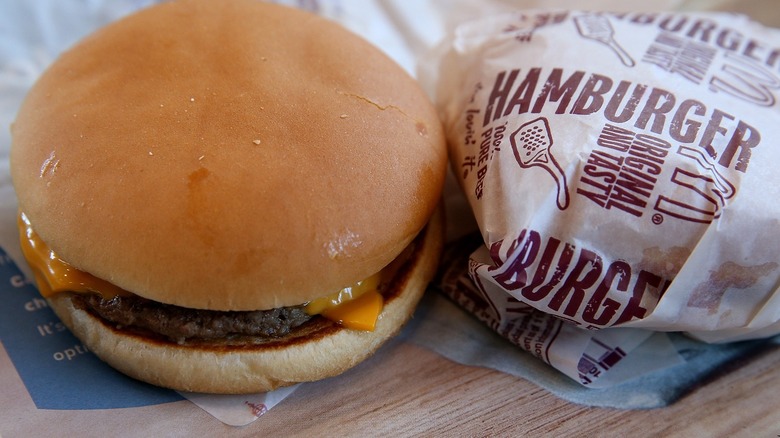 McDonald's cheeseburger next to wrapper