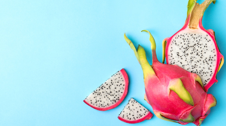 sliced dragon fruit on blue background