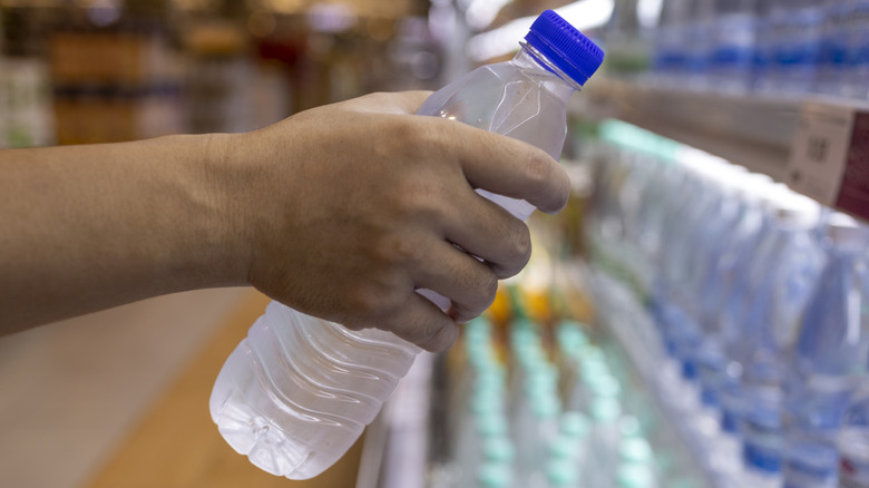 hand around water bottle