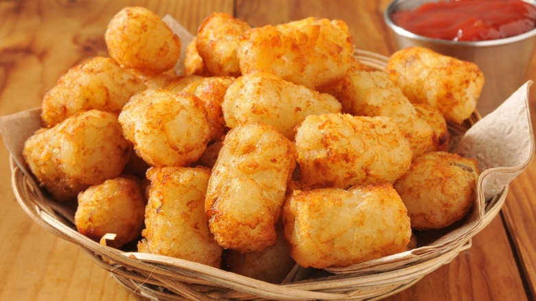 basket of tater tots with ketchup