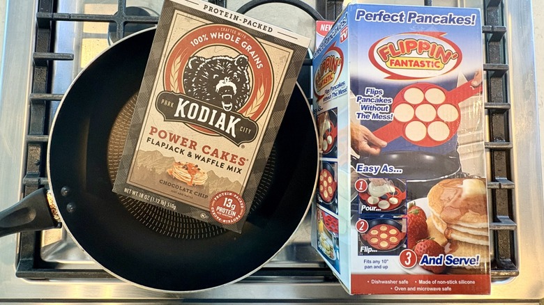 The Flippin' Fantastic in a box along with a pan and pancake mix on the stovetop