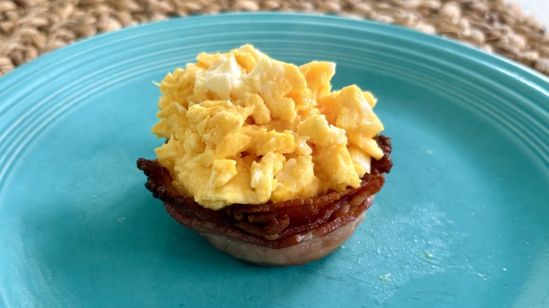 A cooked Perfect Bacon Bowl filled with scrambled eggs, As Seen On TV