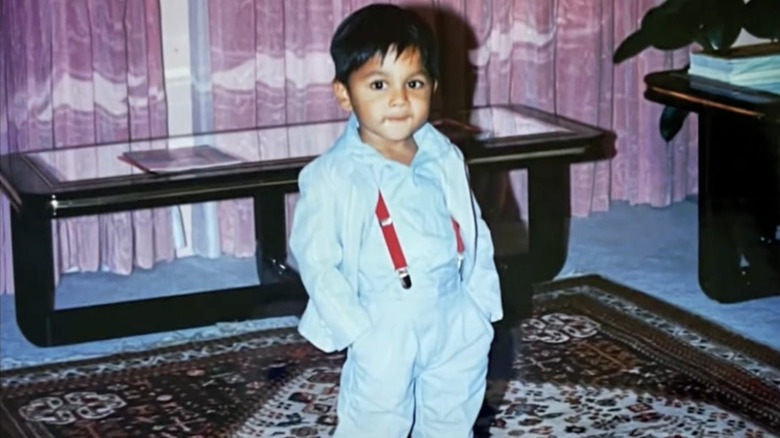 Young Ashish Alfred in a light blue suit