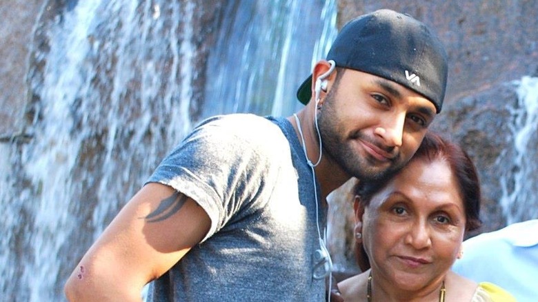 Ashish Alfred and mother pose near waterfall