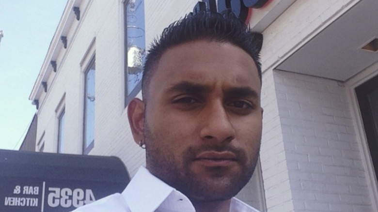 Ashish Alfred stands outside 4935 Bar and Kitchen