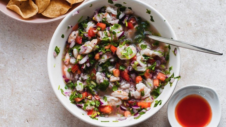 Ceviche served in a dish with chips and sauce