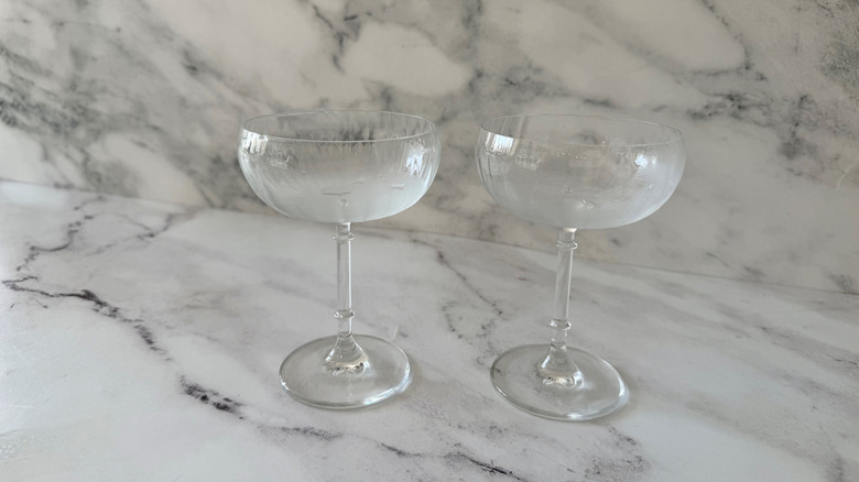Chilled coupe glasses on countertop