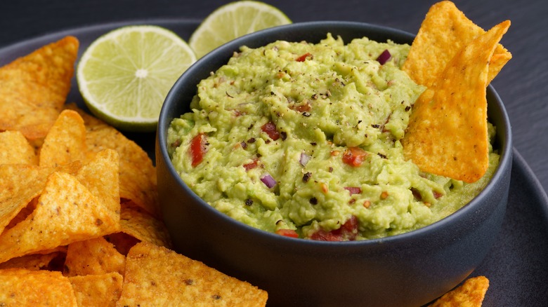 guacamole and tortilla chips with lime