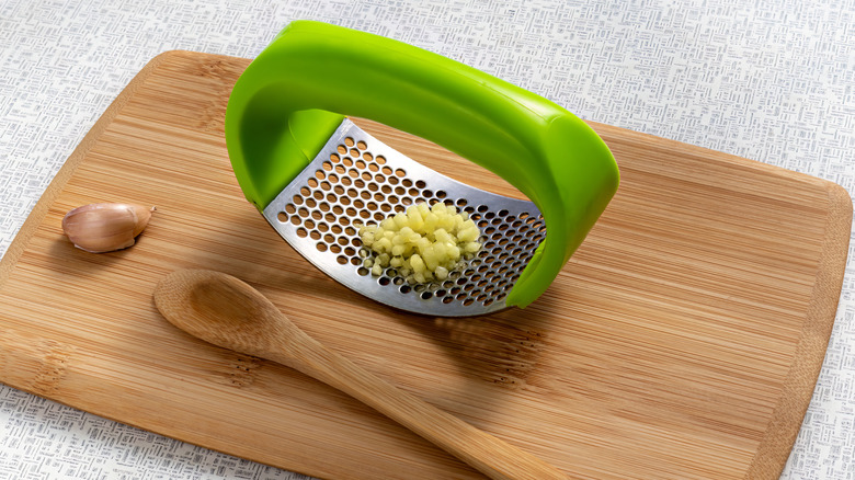 Bright green garlic press rocker with cutting board