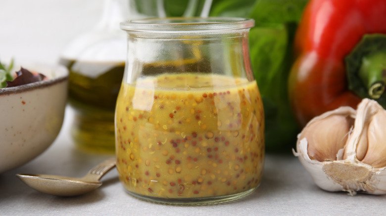 Vinaigrette in jar next to garlic