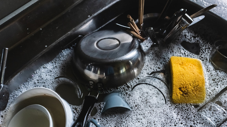 Dirty dishes soaking in soapy water