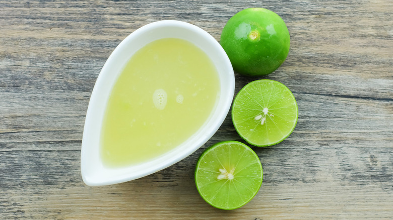 Limes next to fresh squeezed juice