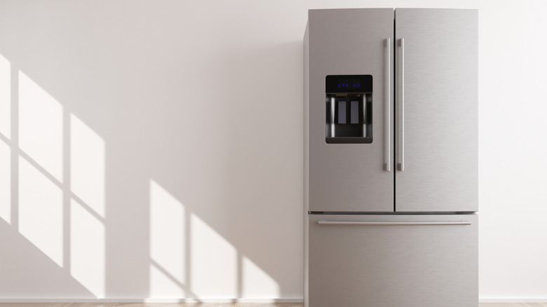 Modern refrigerator in empty room