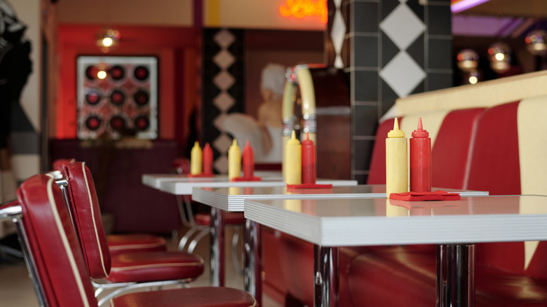 Retro diner interior with red and white booths
