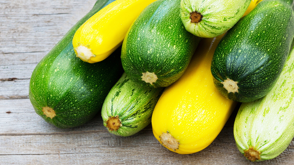 Yellow and green zucchini stacked on each other