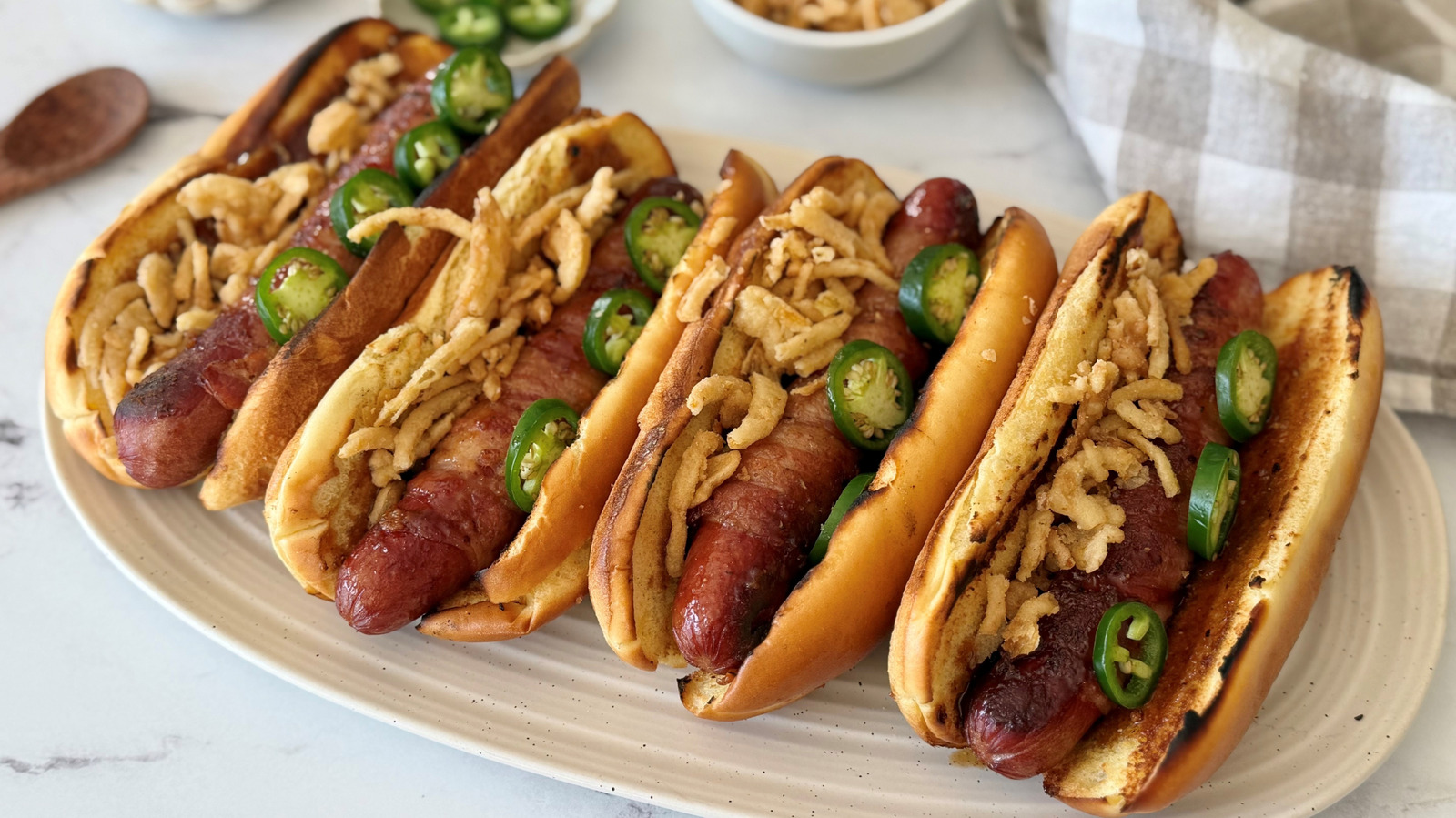 These Bacon-Wrapped Hot Dogs Bring Sweet, Smoky, And Spicy Flavor To The Grill