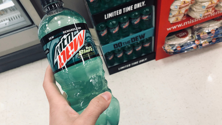 Hand holding bottle of Baja Blast