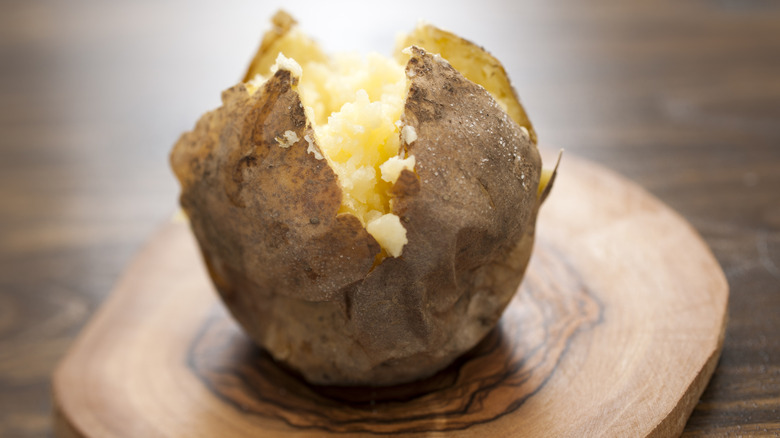 Baked potato on wooden surface