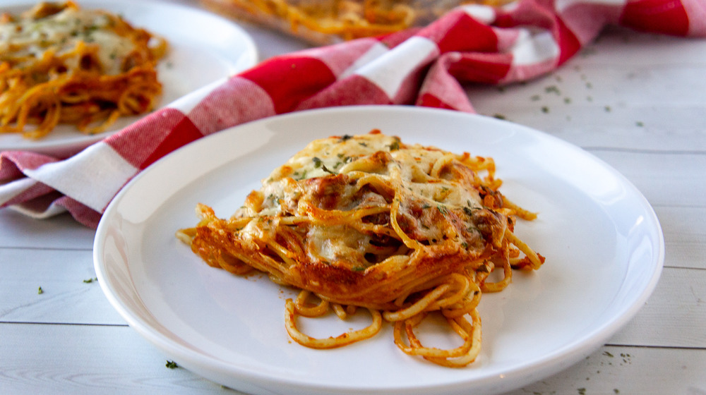 a serving of baked spaghetti on a white plate