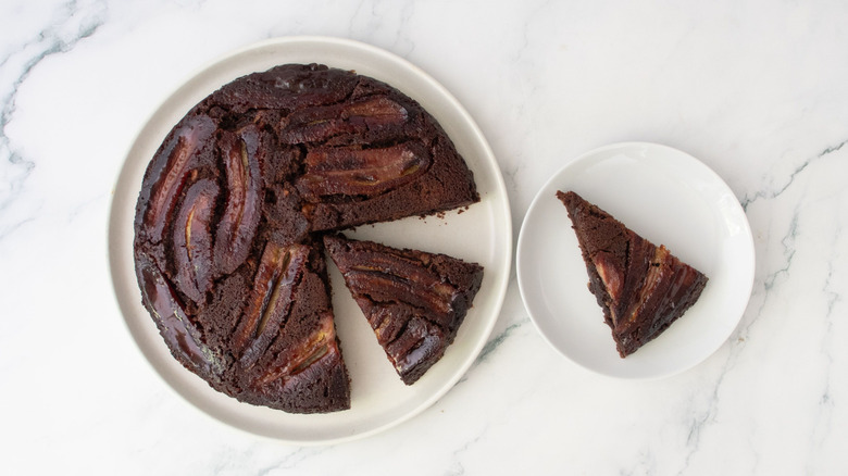 Bananas Foster brownie with slices removed next to slice on plate